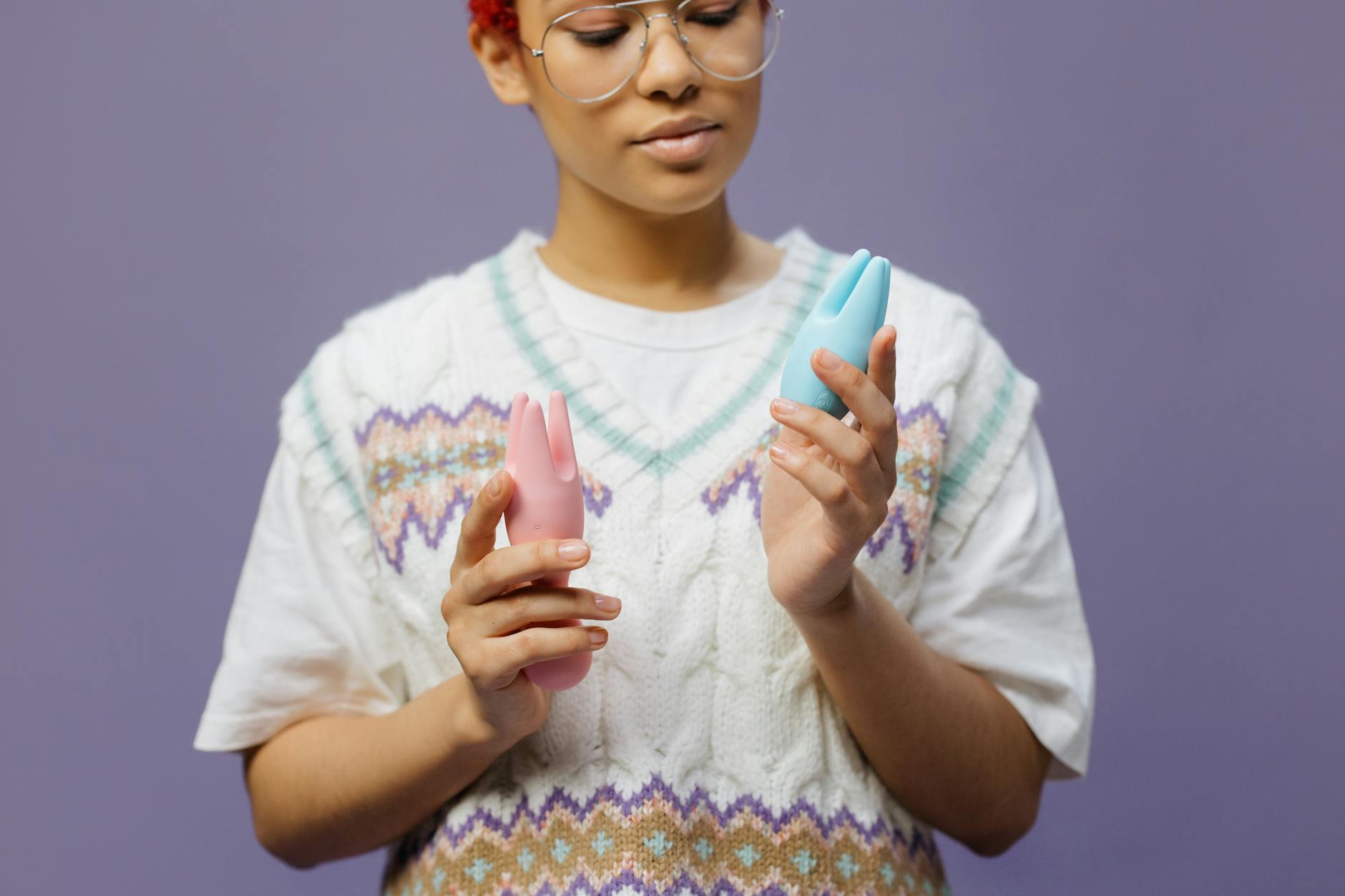 Person holding a vibrator in contemplative moment while rebuilding pleasure after stress