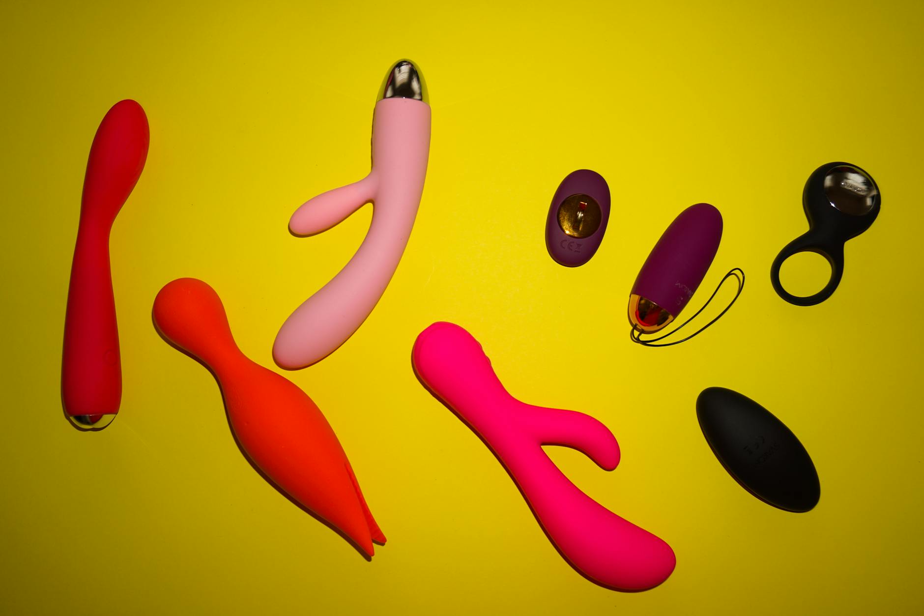 Yellow silicone clitoral vibrator on bright background symbolizing safe postpartum pleasure