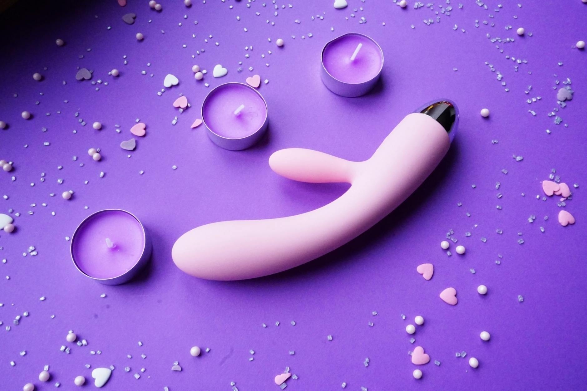 Colorful clitoral vibrators arranged on a bright yellow background, showcasing different shapes and intensity options